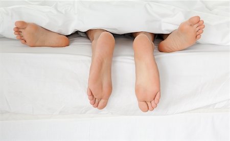 sleeping bed full body - Close up of couple's feet while hugging in their bed at home Stock Photo - Budget Royalty-Free & Subscription, Code: 400-04296742