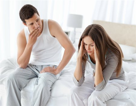Worried man looking at his girlfriend having a headache on the bed at home Stock Photo - Budget Royalty-Free & Subscription, Code: 400-04296743