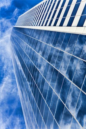 HDR Photograph of the exterior of a modern office city building skyscraper reaching into a blue sky with  clouds Stock Photo - Budget Royalty-Free & Subscription, Code: 400-04296860