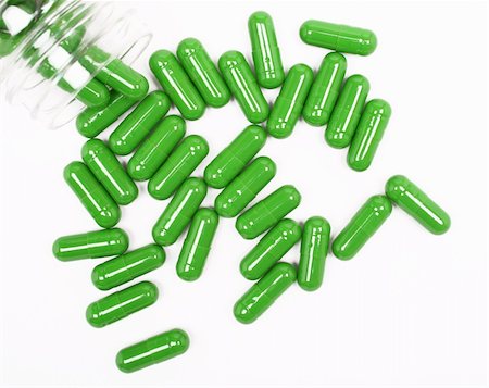 Green pills on white background Foto de stock - Super Valor sin royalties y Suscripción, Código: 400-04296914