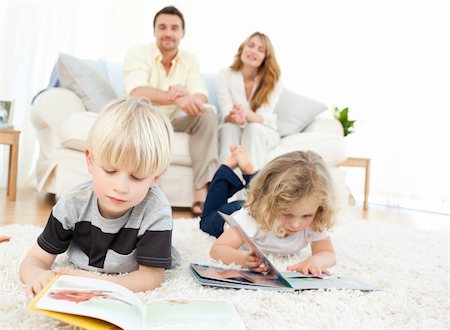 family on sofa popcorn - Childrens reading books in the living rooms Stock Photo - Budget Royalty-Free & Subscription, Code: 400-04297361