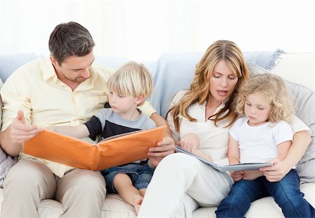 simsearch:400-04193532,k - Family reading a book on their sofa at home Stock Photo - Budget Royalty-Free & Subscription, Code: 400-04297362
