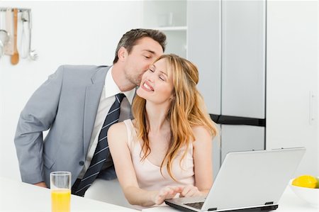 shirt tight man - Businessman kissing his girlfriend at home Stock Photo - Budget Royalty-Free & Subscription, Code: 400-04297385