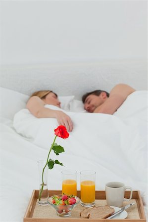 Lovers sleeping after having breakfast in their bed Stock Photo - Budget Royalty-Free & Subscription, Code: 400-04297415