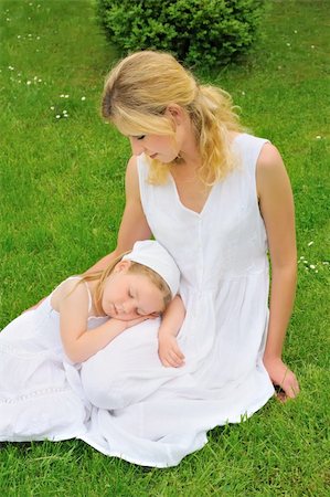 Young mother and daughter resting in meadow Stock Photo - Budget Royalty-Free & Subscription, Code: 400-04297782