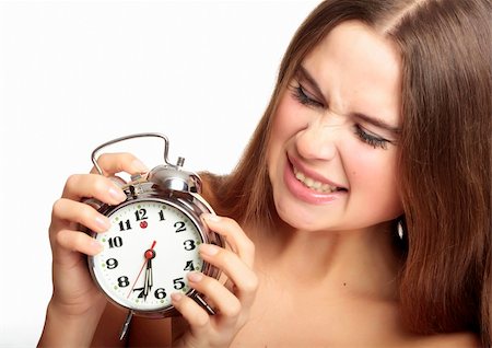 scared girl holding an alarm clock in the hands Fotografie stock - Microstock e Abbonamento, Codice: 400-04297883