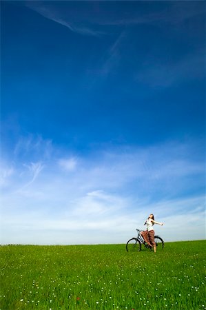simsearch:400-04201795,k - Happy young woman with a vintage bicycle on a green meadow Stock Photo - Budget Royalty-Free & Subscription, Code: 400-04298040