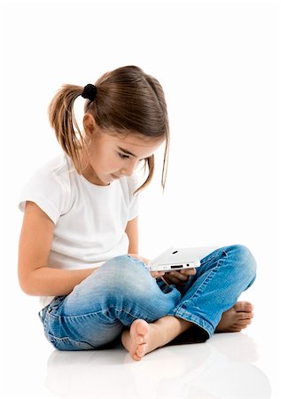 Little girl sitting on floor playing a video-game Stock Photo - Budget Royalty-Free & Subscription, Code: 400-04298064