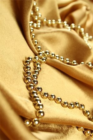 simsearch:630-02220514,k - Background of gold cloth on which lay the golden beads Stockbilder - Microstock & Abonnement, Bildnummer: 400-04298274