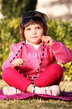 A picture of a cute baby girl putting on a lip gloss and playing with mum's neckllace in the park Stock Photo - Budget Royalty-Free & Subscription, Code: 400-04298729