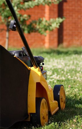yellow lawn mower on green grass Stock Photo - Budget Royalty-Free & Subscription, Code: 400-04298804
