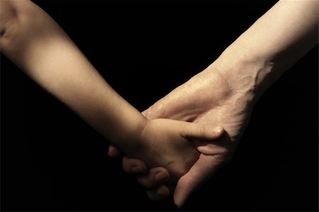 Mother and daughter's hands on black background. Foto de stock - Royalty-Free Super Valor e Assinatura, Número: 400-04299447