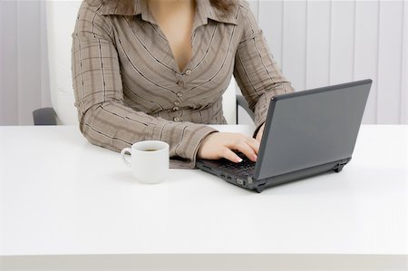 download - girl with a laptop works in an office. Part of the body Fotografie stock - Microstock e Abbonamento, Codice: 400-04299522