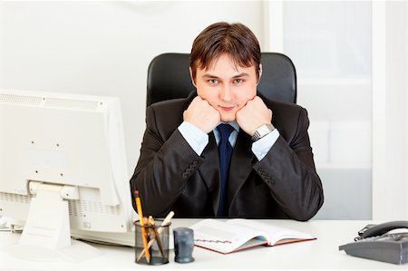 simsearch:400-05900668,k - Business man sitting at office desk and keep head on hands Stock Photo - Budget Royalty-Free & Subscription, Code: 400-04290247