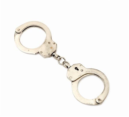 Photo of a pair of handcuffs isolated on a white background Stock Photo - Budget Royalty-Free & Subscription, Code: 400-04290407