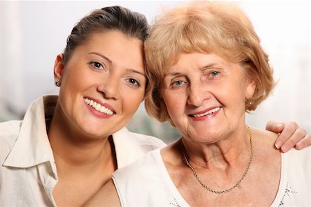 simsearch:400-04300757,k - A beautiful portrait of grandma and grandaughter smiling over white background Photographie de stock - Aubaine LD & Abonnement, Code: 400-04291232