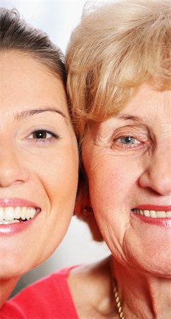 simsearch:400-04300757,k - A picture of a grandma and grandaughter smiling over bright background Photographie de stock - Aubaine LD & Abonnement, Code: 400-04291233