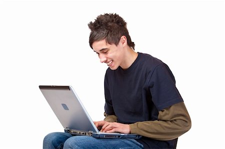 download - Happy male teenager sitting at computer and surfing in the internet. Isolated on white background. Fotografie stock - Microstock e Abbonamento, Codice: 400-04292712