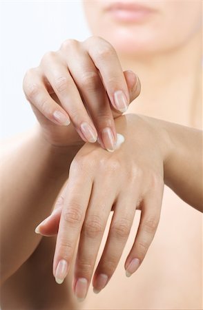 simsearch:400-04127590,k - woman hands applying moisturizing cream to her skin Stock Photo - Budget Royalty-Free & Subscription, Code: 400-04293834