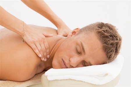 Young blond man enjoying massage session in spa resort Stock Photo - Budget Royalty-Free & Subscription, Code: 400-04304425