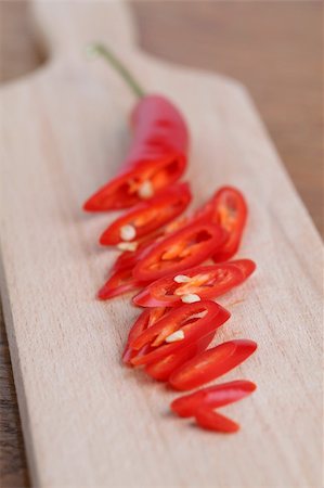 simsearch:600-05973313,k - Sliced red chili pepper on a cutting board. Shallow dof Photographie de stock - Aubaine LD & Abonnement, Code: 400-04304613