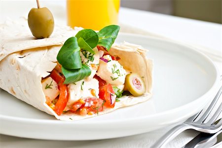 Lavash with a cheese filling, tomato, spinach, olives and a glass of juice. Foto de stock - Royalty-Free Super Valor e Assinatura, Número: 400-04304689