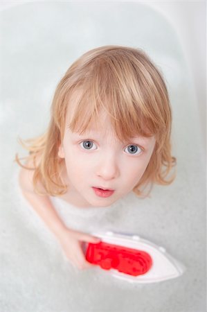 boy with long blond hair playing with plastic boat in bathtub Stock Photo - Budget Royalty-Free & Subscription, Code: 400-04304756