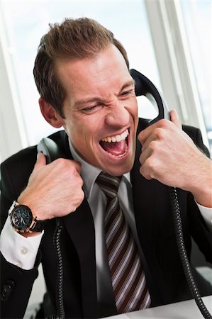 simsearch:400-09030070,k - Stressed young businessman screaming on the phone Stock Photo - Budget Royalty-Free & Subscription, Code: 400-04304910