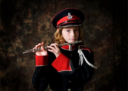 piccolo - portrait of a twelve year old girl wearing her marching band uniform holding her flute low-key studio shot Stock Photo - Budget Royalty-Free & Subscription, Code: 400-04305476
