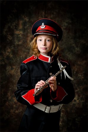 piccolo - portrait of a twelve year old girl wearing her marching band uniform holding her flute low-key studio shot Stock Photo - Budget Royalty-Free & Subscription, Code: 400-04305477