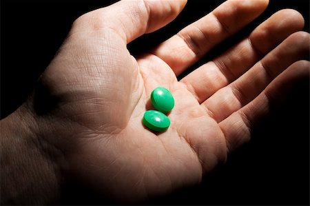 Two green pills on the opened palm Stock Photo - Budget Royalty-Free & Subscription, Code: 400-04305919