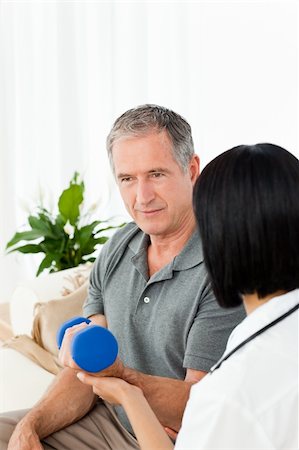 simsearch:400-04809124,k - Nurse helping her patient to do exercises at home Stockbilder - Microstock & Abonnement, Bildnummer: 400-04306395