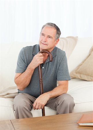 Mature man thoughtful with his walking stick on his bed at home Stock Photo - Budget Royalty-Free & Subscription, Code: 400-04306404