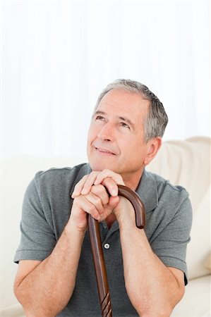 Mature man thoughtful with his walking stick on his bed at home Stock Photo - Budget Royalty-Free & Subscription, Code: 400-04306405