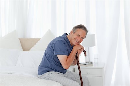 Retired man with his walking stick on his bed Stock Photo - Budget Royalty-Free & Subscription, Code: 400-04306428