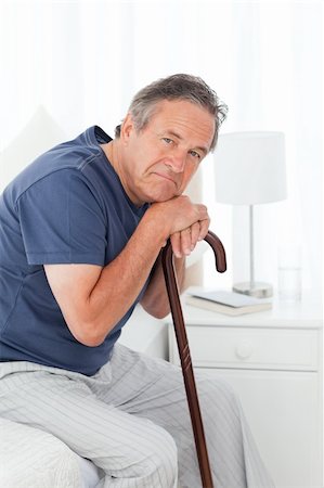 Retired man with his walking stick on his bed Stock Photo - Budget Royalty-Free & Subscription, Code: 400-04306420