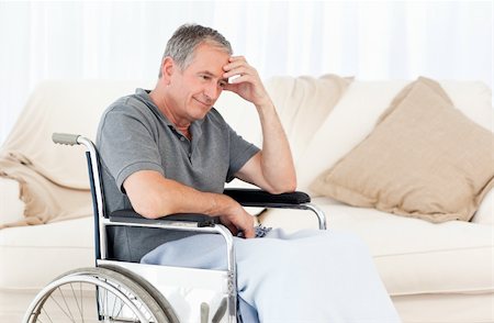 simsearch:400-04327098,k - Senior in his wheelchair having a headache at home Stock Photo - Budget Royalty-Free & Subscription, Code: 400-04306437