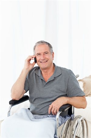 simsearch:400-04327098,k - Senior in his wheelchair phoning at home Stock Photo - Budget Royalty-Free & Subscription, Code: 400-04306454