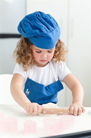 rolling over - Little girl baking in the kitchen at home Stock Photo - Budget Royalty-Free & Subscription, Code: 400-04306455