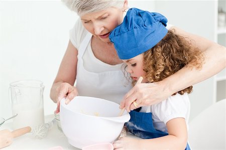 rolling over - A little girl  baking with her grandmother at home Stock Photo - Budget Royalty-Free & Subscription, Code: 400-04306469