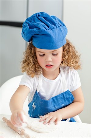 rolling over - Little girl baking in the kitchen at home Stock Photo - Budget Royalty-Free & Subscription, Code: 400-04306460