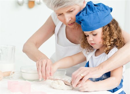 rolling over - A little girl baking with her grandmother at home Stock Photo - Budget Royalty-Free & Subscription, Code: 400-04306489