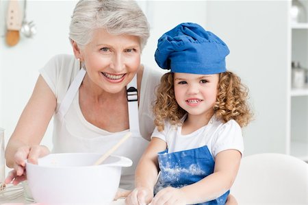 A little girl with her grandmother looking at the camera at home Stock Photo - Budget Royalty-Free & Subscription, Code: 400-04306481