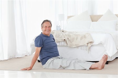 Mature man stretching in his bedroom Stock Photo - Budget Royalty-Free & Subscription, Code: 400-04306497