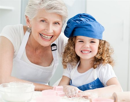 A little girl with her grandmother looking at the camera at home Stock Photo - Budget Royalty-Free & Subscription, Code: 400-04306508