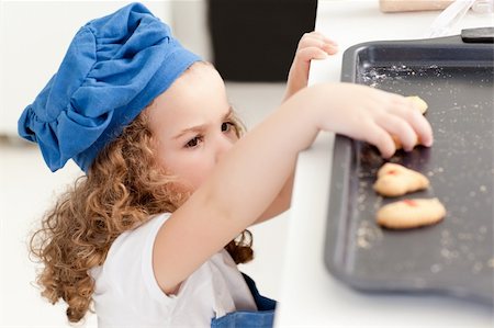 rolling over - Little girl stealing cookies at home Stock Photo - Budget Royalty-Free & Subscription, Code: 400-04306517