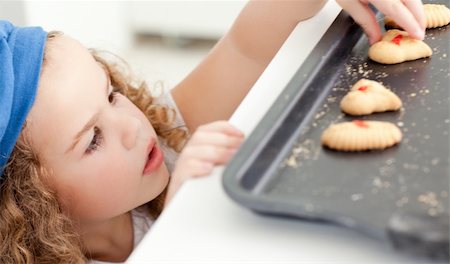 rolling over - Little girl stealing cookies at home Stock Photo - Budget Royalty-Free & Subscription, Code: 400-04306518