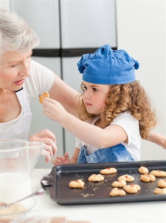 A little girl baking with her grandmother at home Stock Photo - Budget Royalty-Free & Subscription, Code: 400-04306511