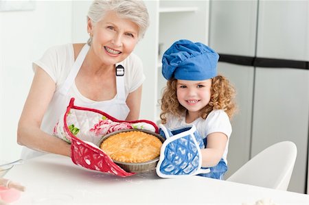 rolling over - A little girl with her grandmother looking at the camera at home Stock Photo - Budget Royalty-Free & Subscription, Code: 400-04306512
