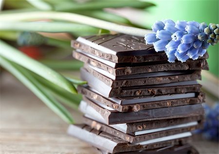 Decorative Stack of Chocolate on wooden board with flower Stock Photo - Budget Royalty-Free & Subscription, Code: 400-04307135